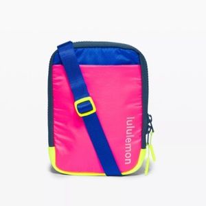 Lululemon East Access Crossbody in hot pink, yellow, and bright blue